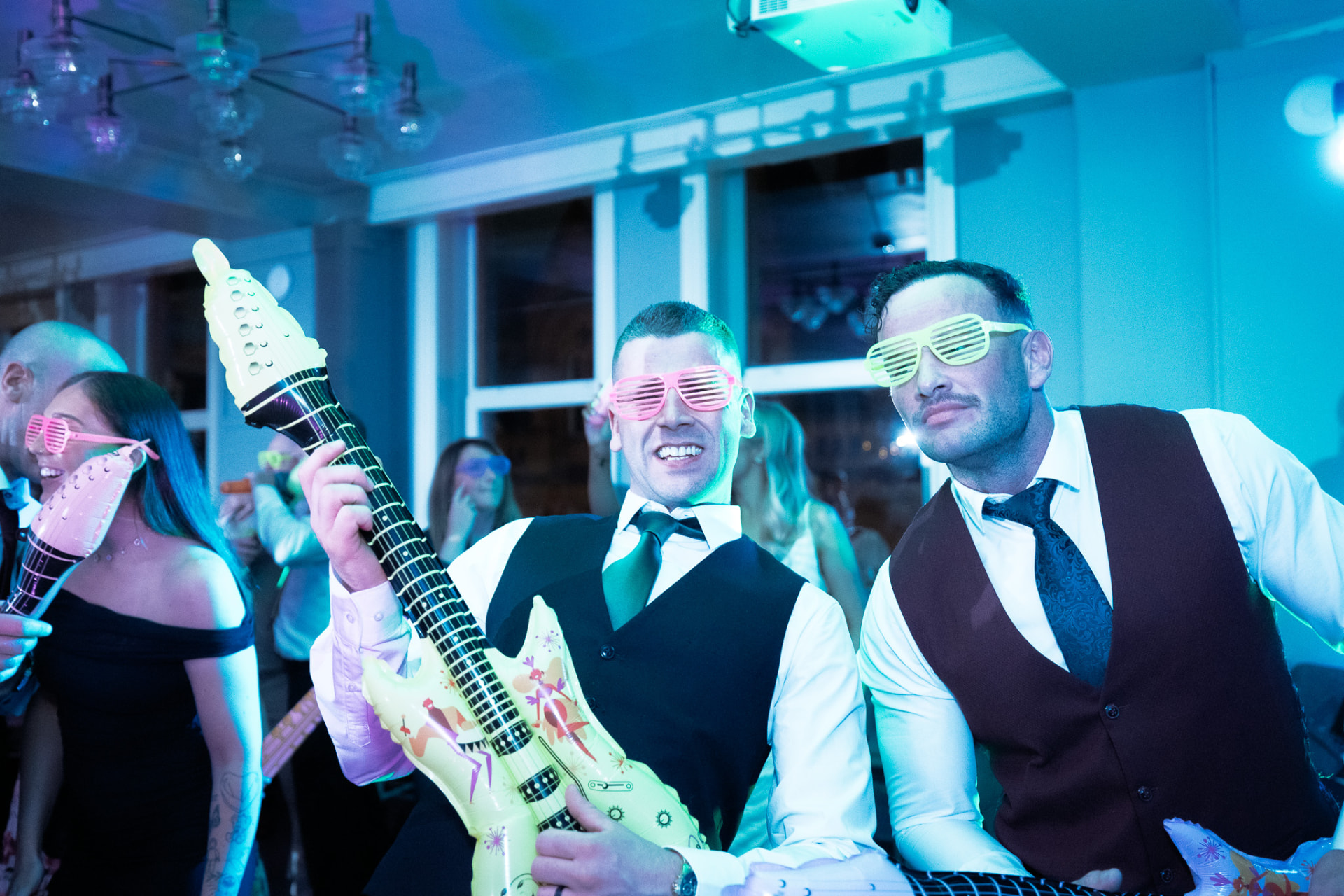 Guests with inflatable guitars on the dancefloor