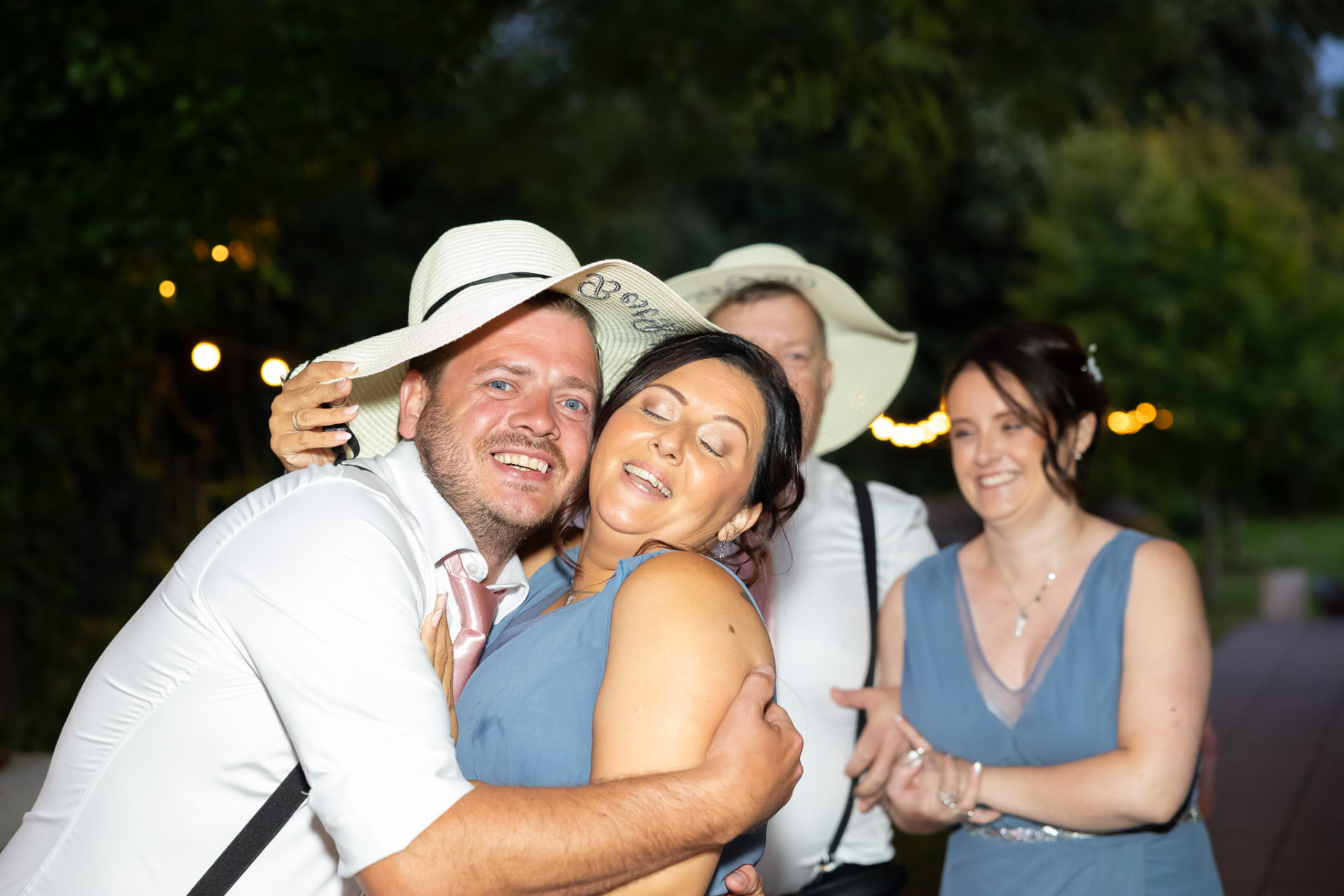 Guests laughing and embracing on the dancefloor