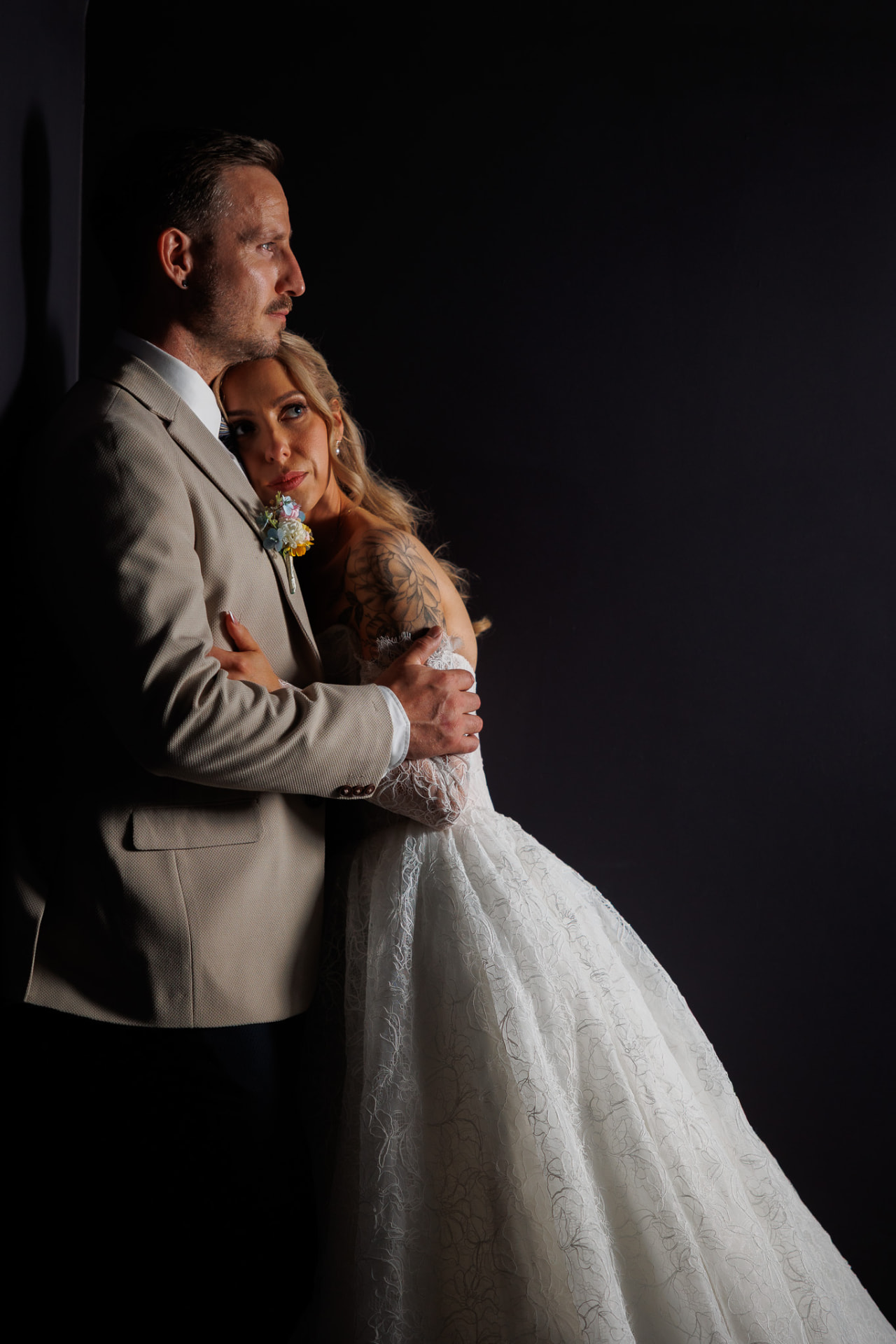 Black and white portrait of a couple in low window light